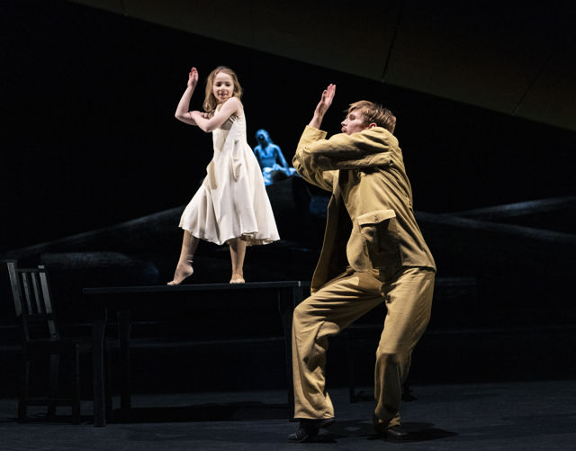 en mann i dress danser med en liten pike i lys kjole